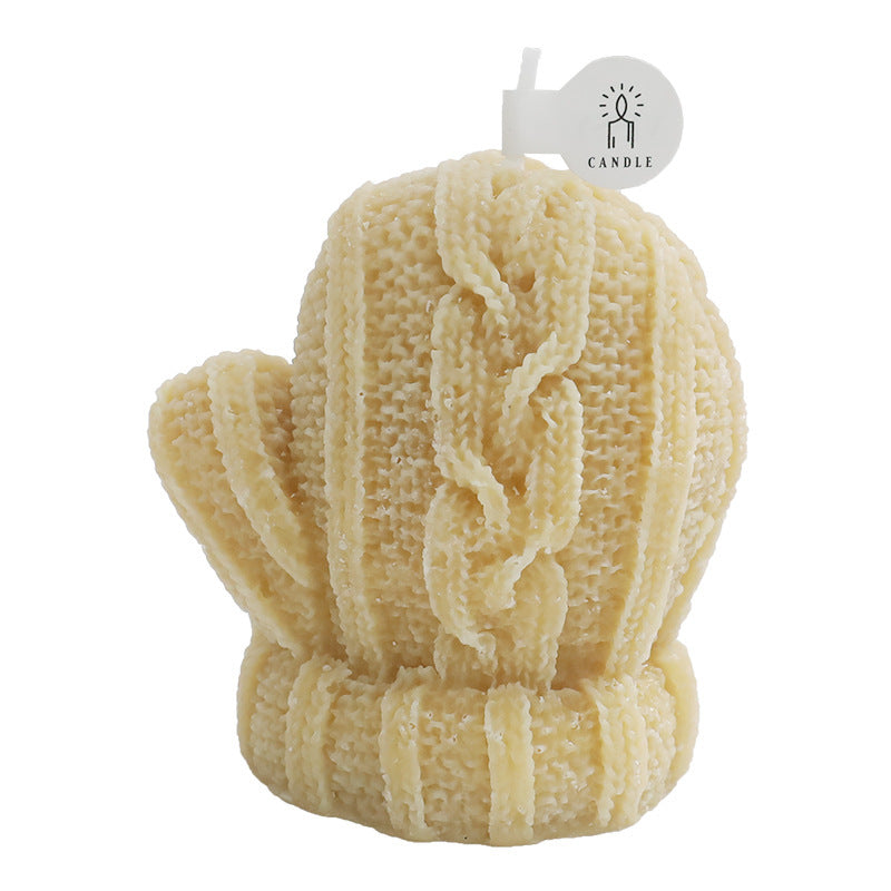  Cozy mittens-shaped candles in various colors including orange, yellow, and green, adding a whimsical touch to home decor. Perfect for winter ambiance and gifting, these handcrafted scented candles are displayed on a wooden table surrounded by books.