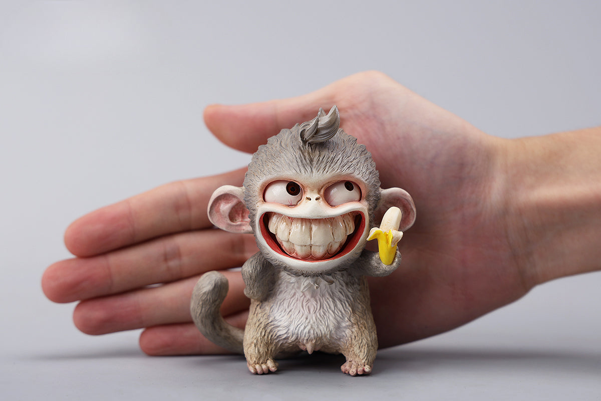 Hand-painted resin monkey figurine featuring a playful expression and banana. Collectible animal figurine with intricate detailing and high-quality craftsmanship. A must-have for monkey lovers, art collectors, and unique home décor enthusiasts.