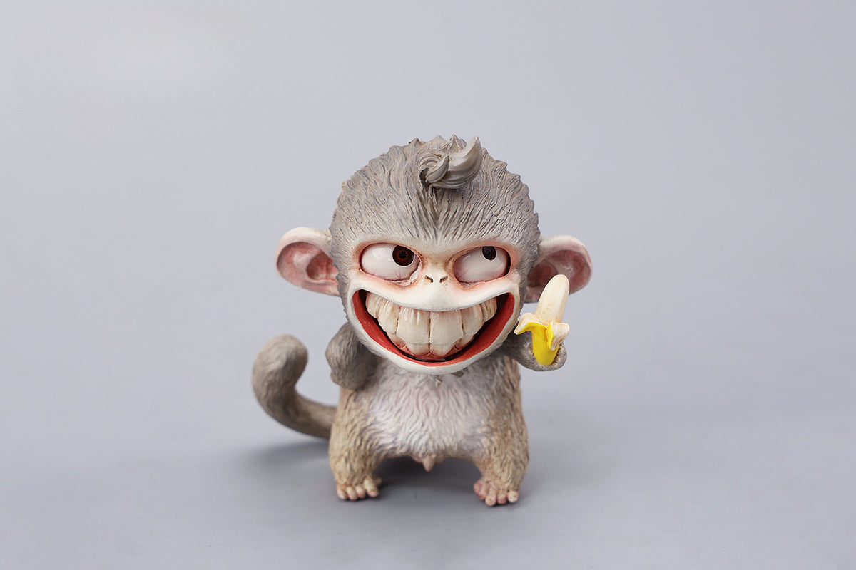 Hand-painted resin monkey figurine featuring a playful expression and banana. Collectible animal figurine with intricate detailing and high-quality craftsmanship. A must-have for monkey lovers, art collectors, and unique home décor enthusiasts.