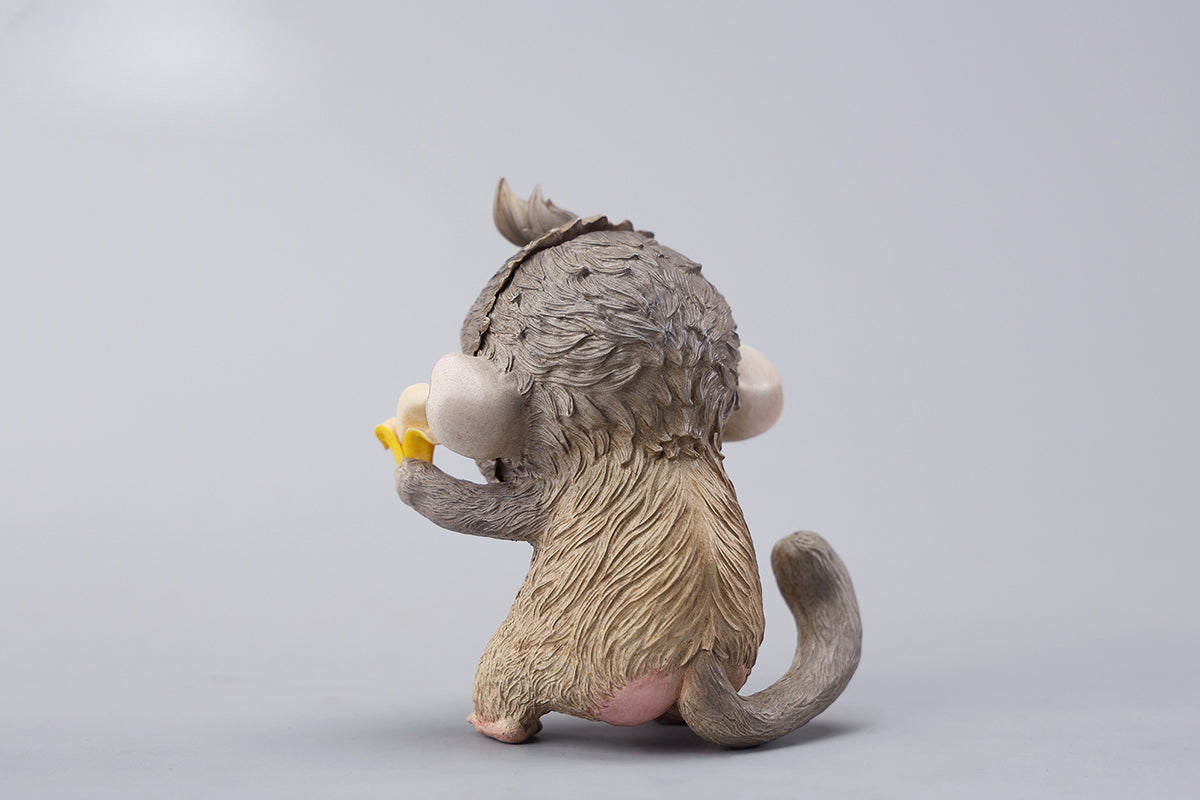 Hand-painted resin monkey figurine featuring a playful expression and banana. Collectible animal figurine with intricate detailing and high-quality craftsmanship. A must-have for monkey lovers, art collectors, and unique home décor enthusiasts.
