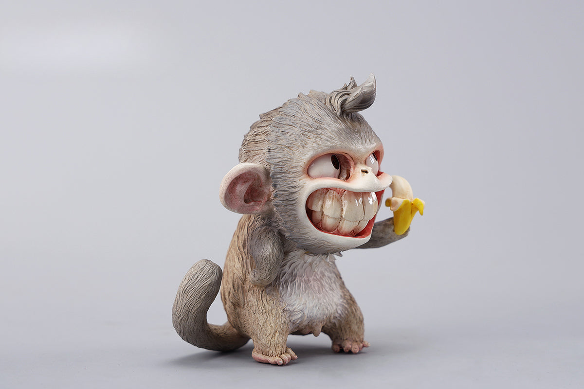 Hand-painted resin monkey figurine featuring a playful expression and banana. Collectible animal figurine with intricate detailing and high-quality craftsmanship. A must-have for monkey lovers, art collectors, and unique home décor enthusiasts.