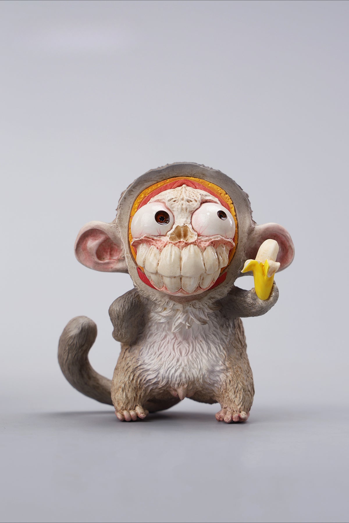 Hand-painted resin monkey figurine featuring a playful expression and banana. Collectible animal figurine with intricate detailing and high-quality craftsmanship. A must-have for monkey lovers, art collectors, and unique home décor enthusiasts.