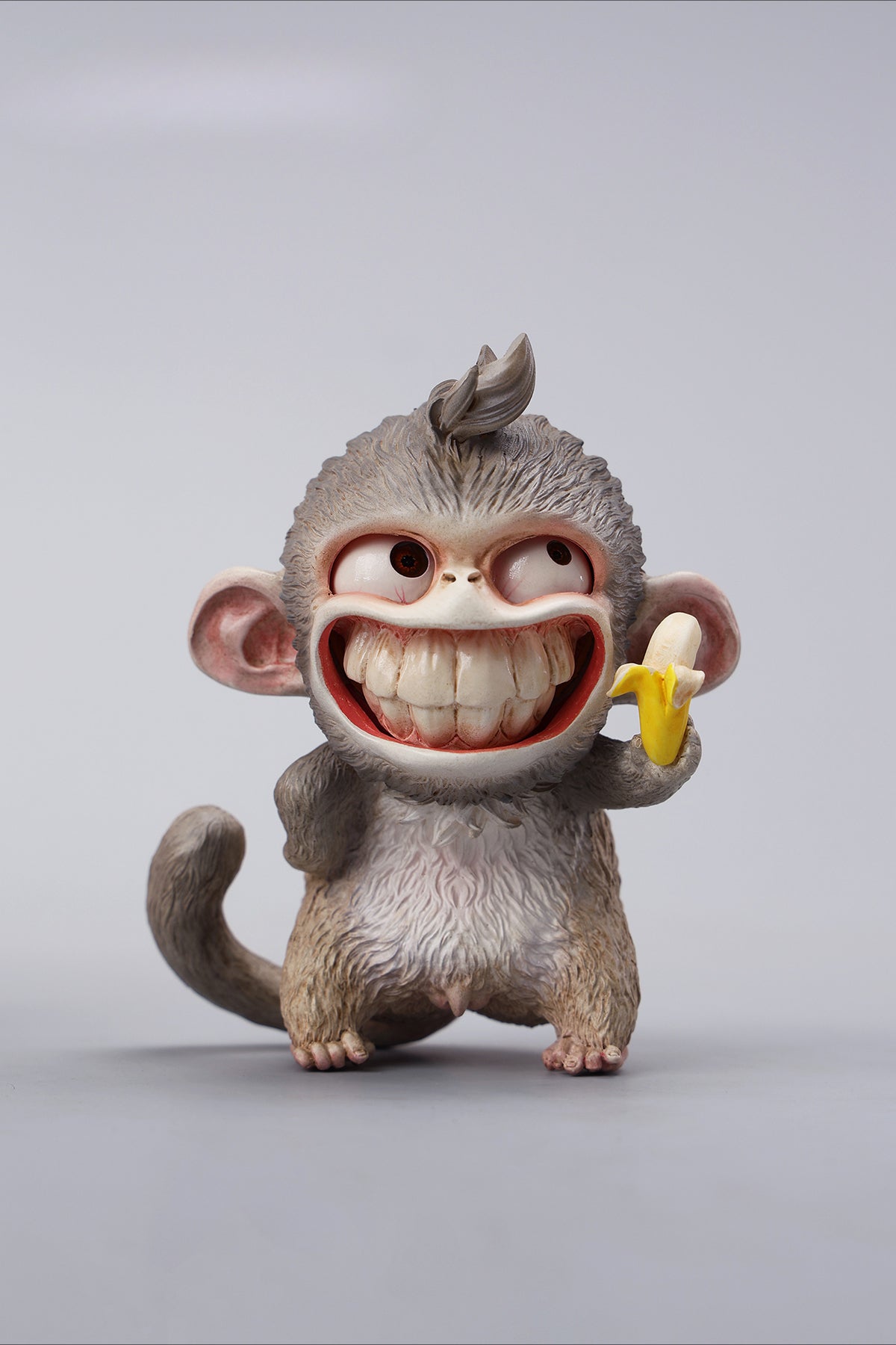 Hand-painted resin monkey figurine featuring a playful expression and banana. Collectible animal figurine with intricate detailing and high-quality craftsmanship. A must-have for monkey lovers, art collectors, and unique home décor enthusiasts.