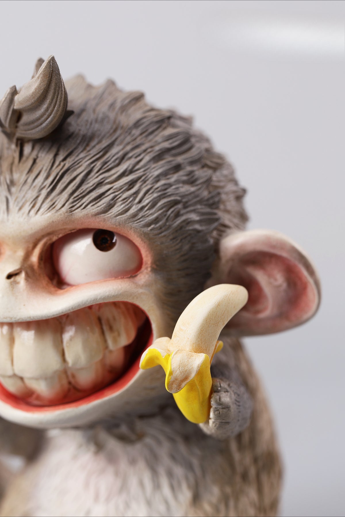 Hand-painted resin monkey figurine featuring a playful expression and banana. Collectible animal figurine with intricate detailing and high-quality craftsmanship. A must-have for monkey lovers, art collectors, and unique home décor enthusiasts.