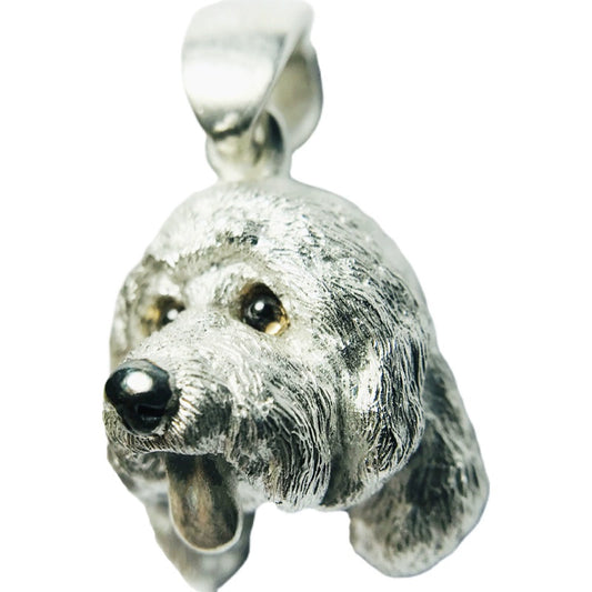 Close-up image of a handcrafted 925 silver poodle dog pendant with detailed fur texture and customizable gemstone eyes, shown in an antique black finish, suspended from a delicate silver chain.