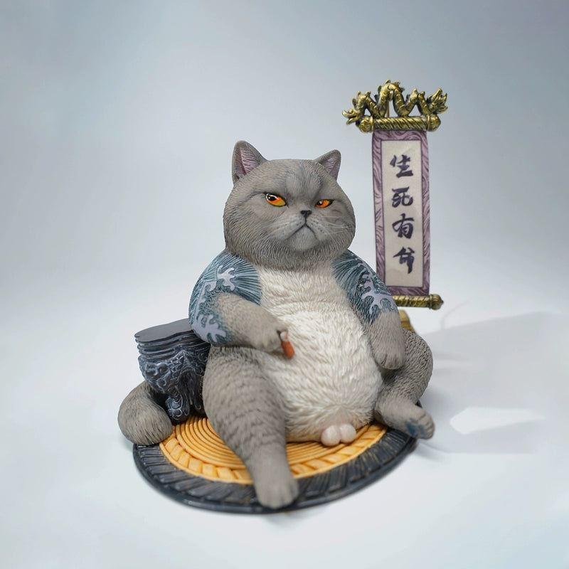 A detailed figurine of the Prophet Garfield Cat Model showcasing a chubby, contented cat with tattoos, sitting relaxed with accessories like a ball of yarn and a traditional scroll, displaying an amusing and unique design.