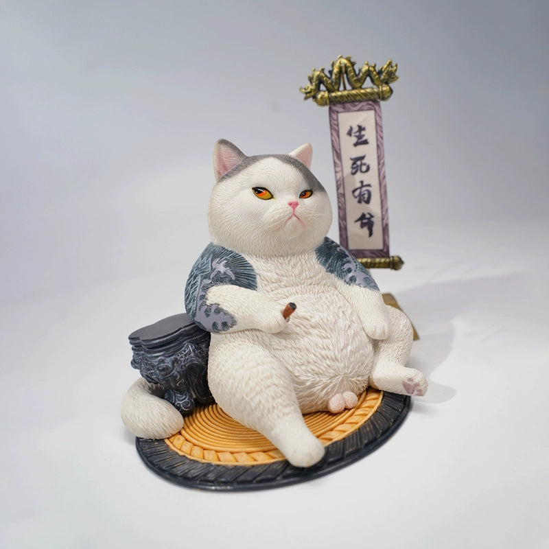 A detailed figurine of the Prophet Garfield Cat Model showcasing a chubby, contented cat with tattoos, sitting relaxed with accessories like a ball of yarn and a traditional scroll, displaying an amusing and unique design.