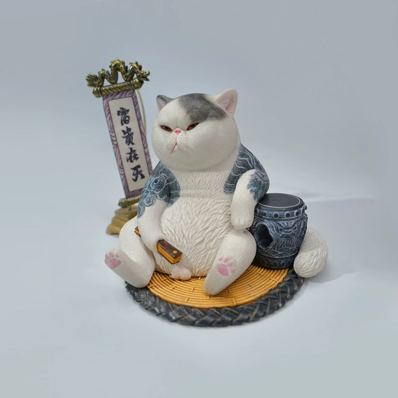 A detailed figurine of the Prophet Garfield Cat Model showcasing a chubby, contented cat with tattoos, sitting relaxed with accessories like a ball of yarn and a traditional scroll, displaying an amusing and unique design.