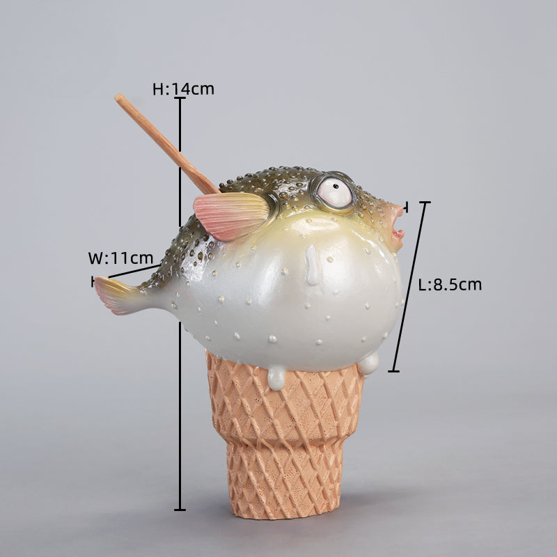 A highly detailed pufferfish ice cream figurine featuring a realistic fish with bulging eyes and textured scales, sitting on an intricately sculpted ice cream cone base. Made of premium resin, this collectible novelty item is perfect for unique decor lovers and marine life enthusiasts.