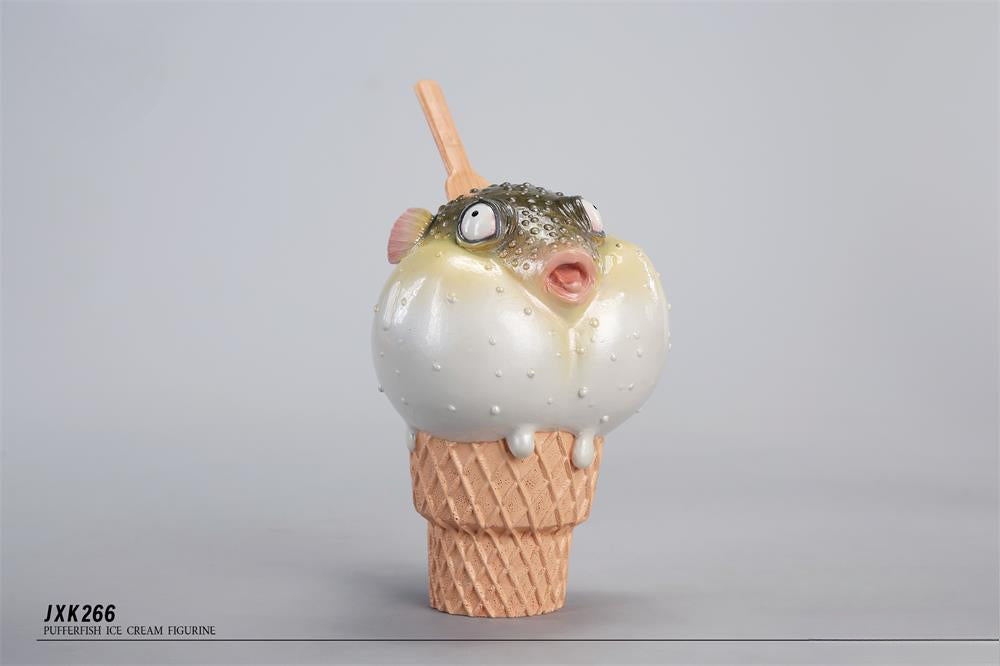 A highly detailed pufferfish ice cream figurine featuring a realistic fish with bulging eyes and textured scales, sitting on an intricately sculpted ice cream cone base. Made of premium resin, this collectible novelty item is perfect for unique decor lovers and marine life enthusiasts.