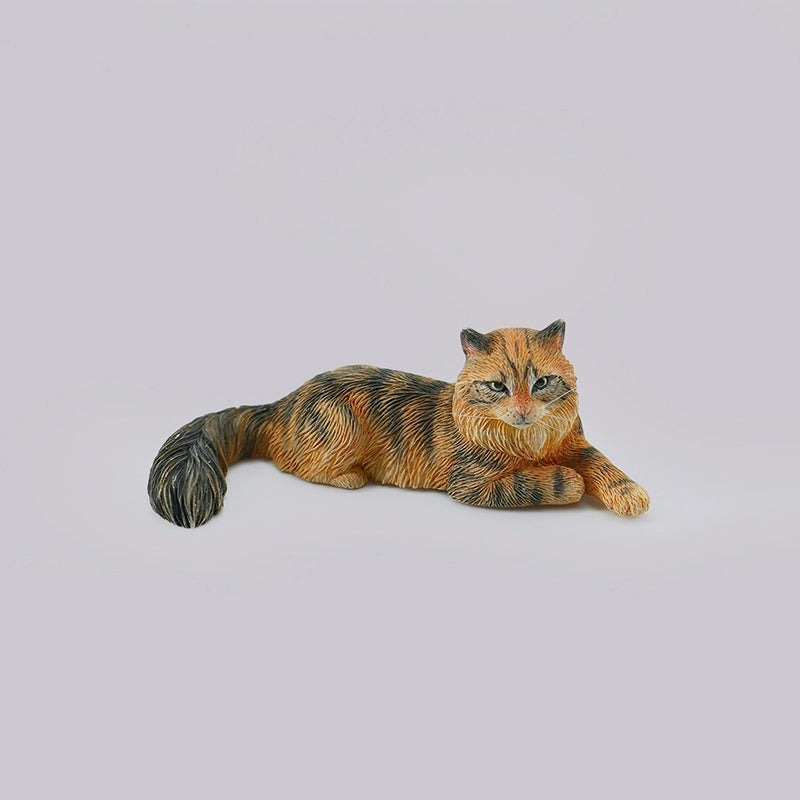 A detailed miniature model of a grey Maine Coon cat, lying in a relaxed position with intricate fur detailing and realistic coloring. This charming collectible captures the essence of a Maine Coon, perfect for cat lovers and model collectors. The cat model is part of a series featuring various poses and colors.