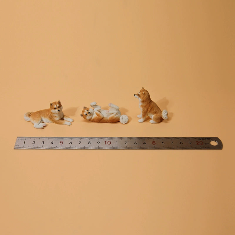 A collection of small Mini Shiba Inu and Labrador dog models showcasing various poses. The Shiba Inu models are in black and tan, while the Labrador models are black. Each model captures lifelike details, perfect for dog lovers and collectors.