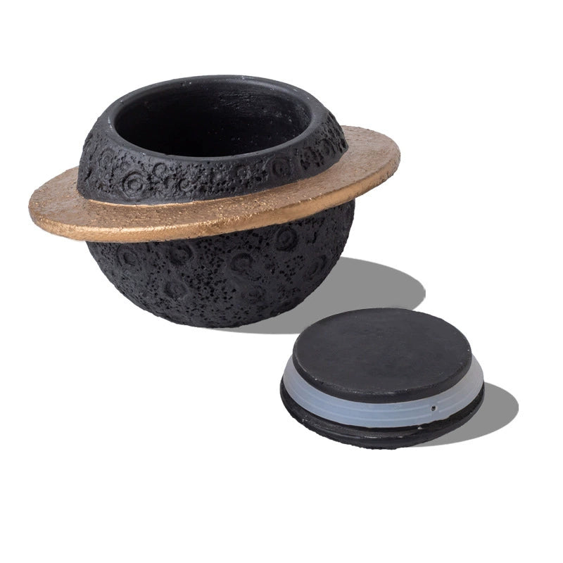 Discover the Pink Saturn-Shaped Pet Urn, a heartfelt memorial ashes holder crafted from durable Portland cement for North American pet owners. This whimsical planet-inspired design in soft pink, complete with a gold ring and textured craters, offers secure storage for up to 400ml of ashes from small pets. Measuring 16.5cm wide and 11cm tall, it weighs 1010g and fits perfectly on shelves or mantels, blending seamlessly into home decor. Ideal for cat or dog lovers seeking a unique tribute, it addresses grief 