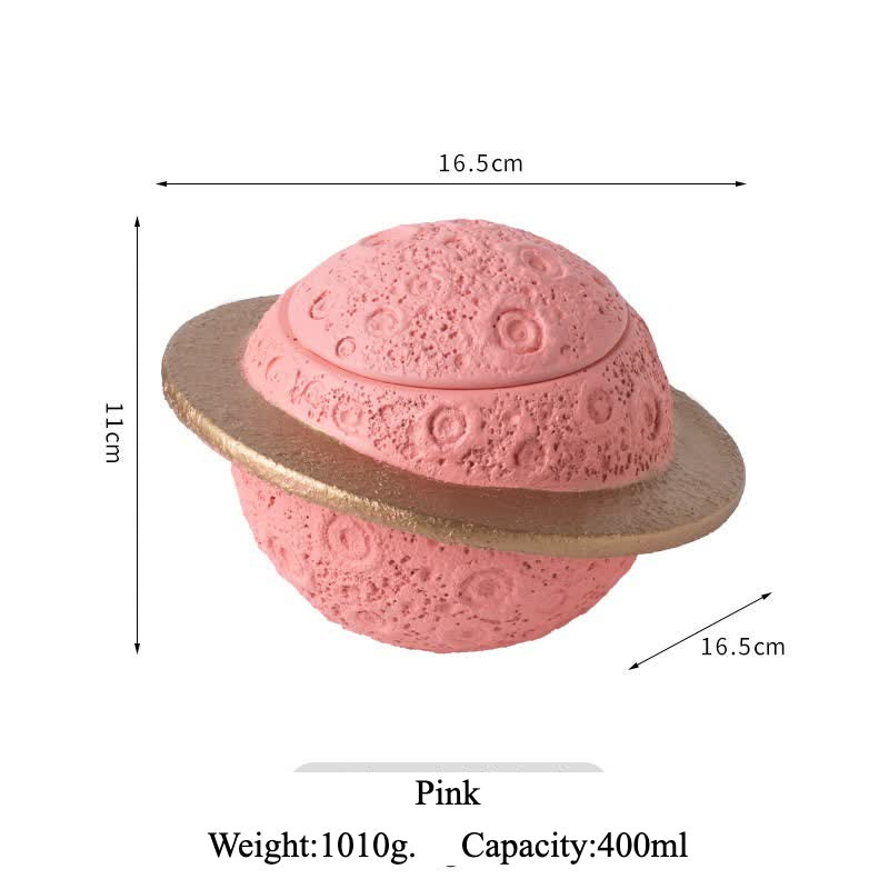Discover the Pink Saturn-Shaped Pet Urn, a heartfelt memorial ashes holder crafted from durable Portland cement for North American pet owners. This whimsical planet-inspired design in soft pink, complete with a gold ring and textured craters, offers secure storage for up to 400ml of ashes from small pets. Measuring 16.5cm wide and 11cm tall, it weighs 1010g and fits perfectly on shelves or mantels, blending seamlessly into home decor. Ideal for cat or dog lovers seeking a unique tribute, it addresses grief 