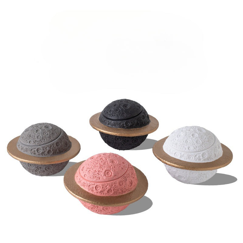 Discover the Pink Saturn-Shaped Pet Urn, a heartfelt memorial ashes holder crafted from durable Portland cement for North American pet owners. This whimsical planet-inspired design in soft pink, complete with a gold ring and textured craters, offers secure storage for up to 400ml of ashes from small pets. Measuring 16.5cm wide and 11cm tall, it weighs 1010g and fits perfectly on shelves or mantels, blending seamlessly into home decor. Ideal for cat or dog lovers seeking a unique tribute, it addresses grief 