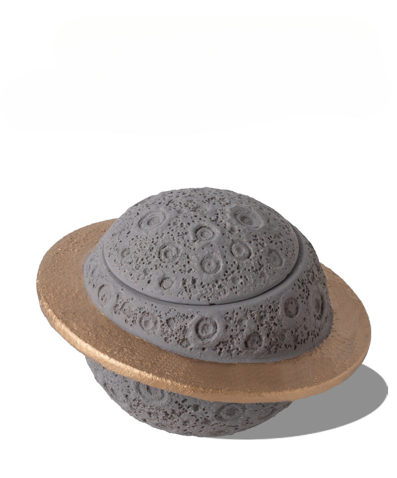 Discover the Pink Saturn-Shaped Pet Urn, a heartfelt memorial ashes holder crafted from durable Portland cement for North American pet owners. This whimsical planet-inspired design in soft pink, complete with a gold ring and textured craters, offers secure storage for up to 400ml of ashes from small pets. Measuring 16.5cm wide and 11cm tall, it weighs 1010g and fits perfectly on shelves or mantels, blending seamlessly into home decor. Ideal for cat or dog lovers seeking a unique tribute, it addresses grief 