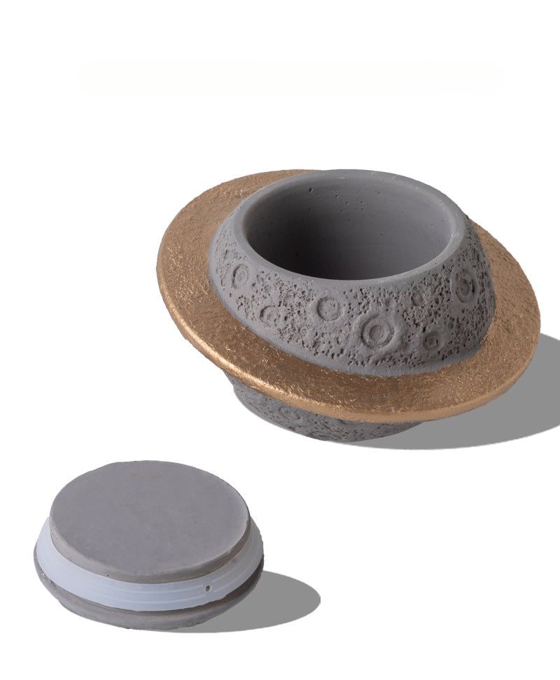 Discover the Pink Saturn-Shaped Pet Urn, a heartfelt memorial ashes holder crafted from durable Portland cement for North American pet owners. This whimsical planet-inspired design in soft pink, complete with a gold ring and textured craters, offers secure storage for up to 400ml of ashes from small pets. Measuring 16.5cm wide and 11cm tall, it weighs 1010g and fits perfectly on shelves or mantels, blending seamlessly into home decor. Ideal for cat or dog lovers seeking a unique tribute, it addresses grief 