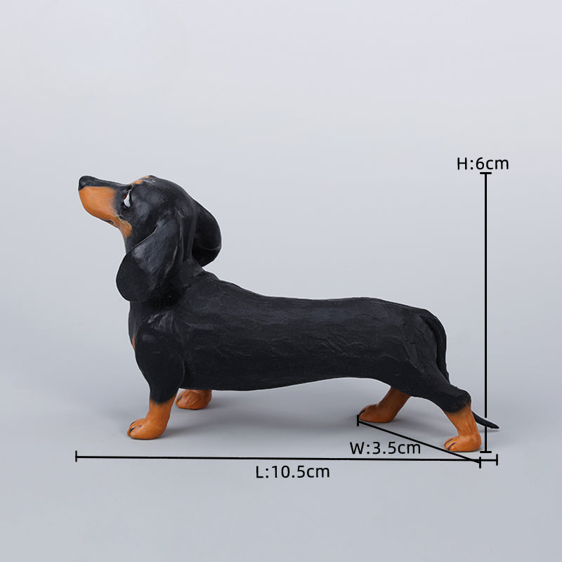 Two small clay Dachshund dog models, one black and one brown, captured in a realistic and lifelike manner. The models showcase detailed features, including expressive eyes and realistic fur textures. Perfect for collectors and dog enthusiasts.