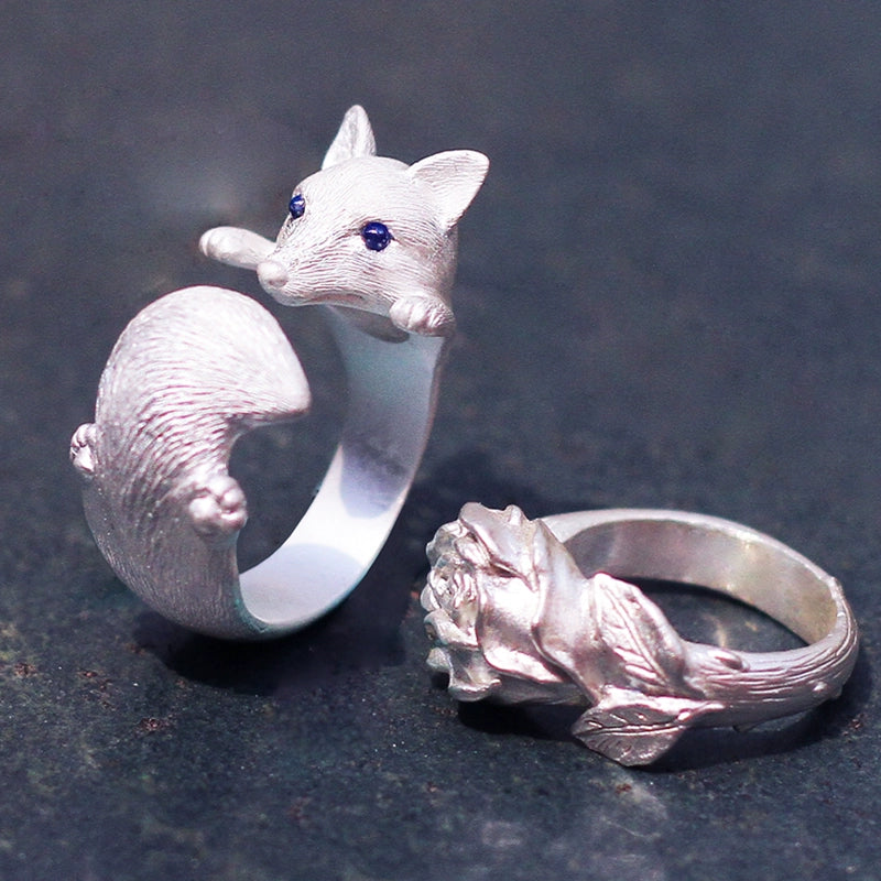 Sterling Silver Fox and Rose Ring featuring detailed fur and petal designs, with gemstone eyes in a secure bezel setting, handcrafted from solid 925 sterling silver, available in silver and antique black finishes, showcasing artisan craftsmanship and unique, customizable design.