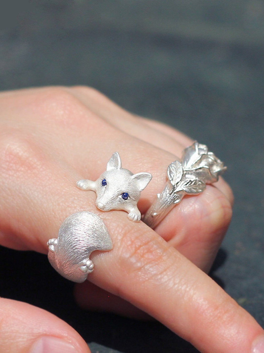 Sterling Silver Fox and Rose Ring featuring detailed fur and petal designs, with gemstone eyes in a secure bezel setting, handcrafted from solid 925 sterling silver, available in silver and antique black finishes, showcasing artisan craftsmanship and unique, customizable design.