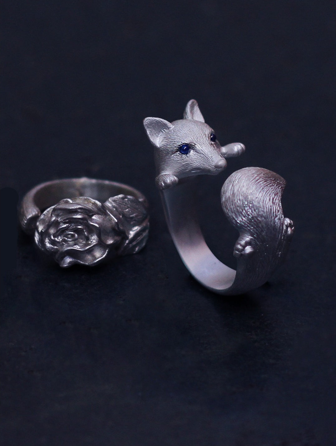 Sterling Silver Fox and Rose Ring featuring detailed fur and petal designs, with gemstone eyes in a secure bezel setting, handcrafted from solid 925 sterling silver, available in silver and antique black finishes, showcasing artisan craftsmanship and unique, customizable design.