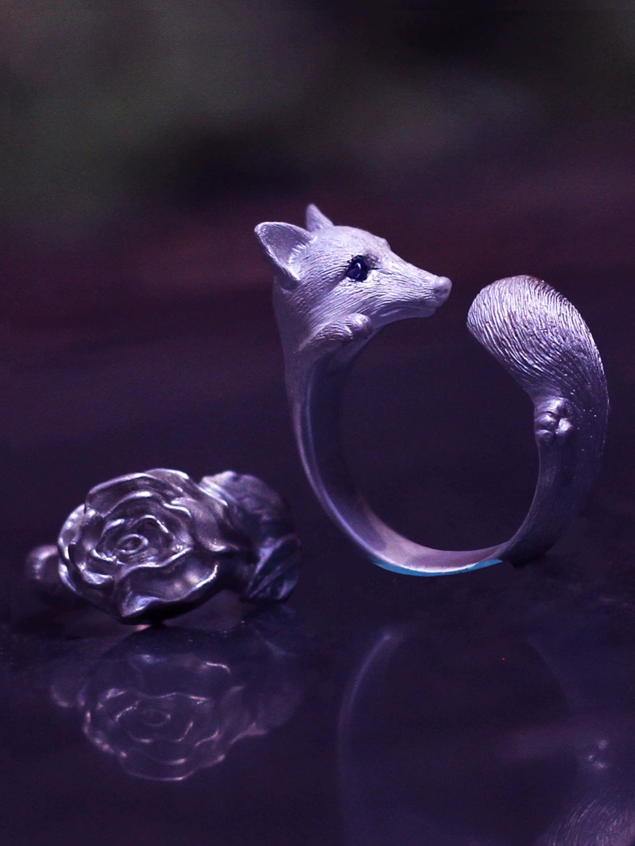 Sterling Silver Fox and Rose Ring featuring detailed fur and petal designs, with gemstone eyes in a secure bezel setting, handcrafted from solid 925 sterling silver, available in silver and antique black finishes, showcasing artisan craftsmanship and unique, customizable design.