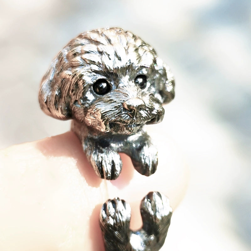 Sterling Silver Teddy Ring featuring a lifelike hand-carved puppy design, available in silver or antique black finish. The ring showcases intricate detailing with black obsidian eyes, making it a unique keepsake for pet lovers.