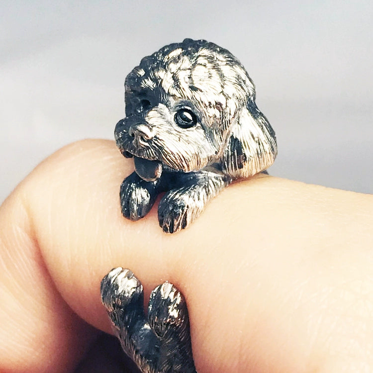 Sterling Silver Teddy Ring featuring a lifelike hand-carved puppy design, available in silver or antique black finish. The ring showcases intricate detailing with black obsidian eyes, making it a unique keepsake for pet lovers.