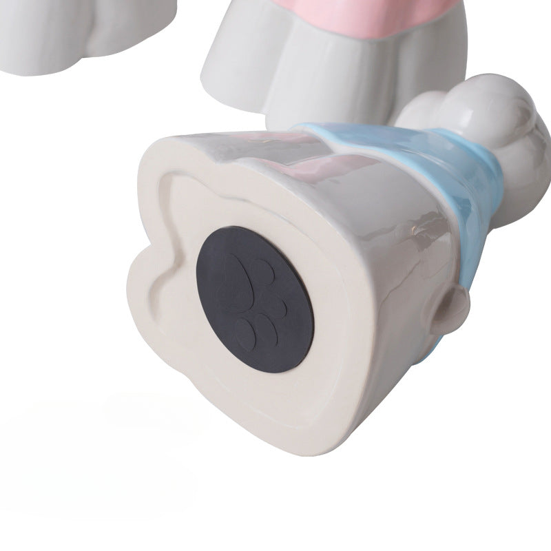 This pink poodle ceramic pet urn features an elegant design with a gold bow tie accent, standing 20.5cm tall, 12.5cm wide, and 11.5cm deep, holding 850ml of ashes. Weighing 589g, it’s perfect for North American pet owners memorializing medium-sized pets like dogs or cats, offering secure storage and a refined display for home shelves or mantels.