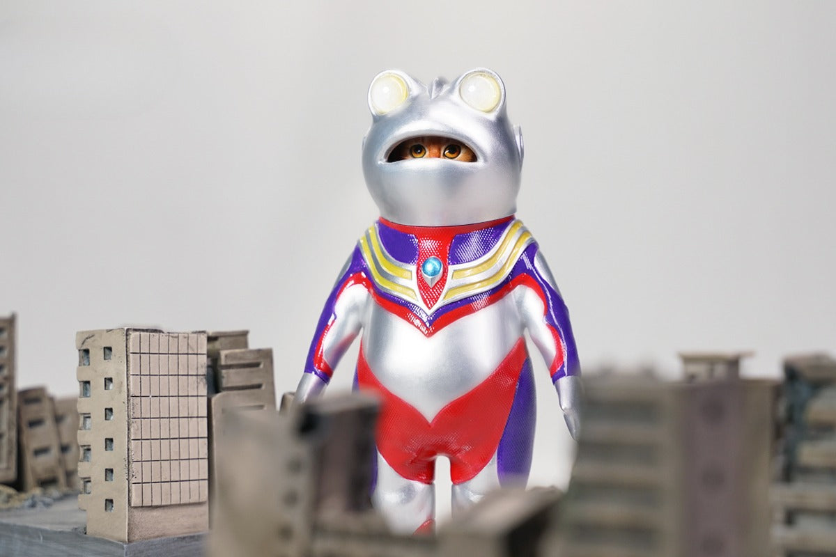 This Ultrafrog action figure features a frog body with a removable cat head sculpture, made of durable vinyl. The figure measures 9 x 5 x 16 cm and includes a magnetic headpiece that can rotate, making it a fun and customizable collectible for fans of unique hybrid figures, superheroes, and creative designs.