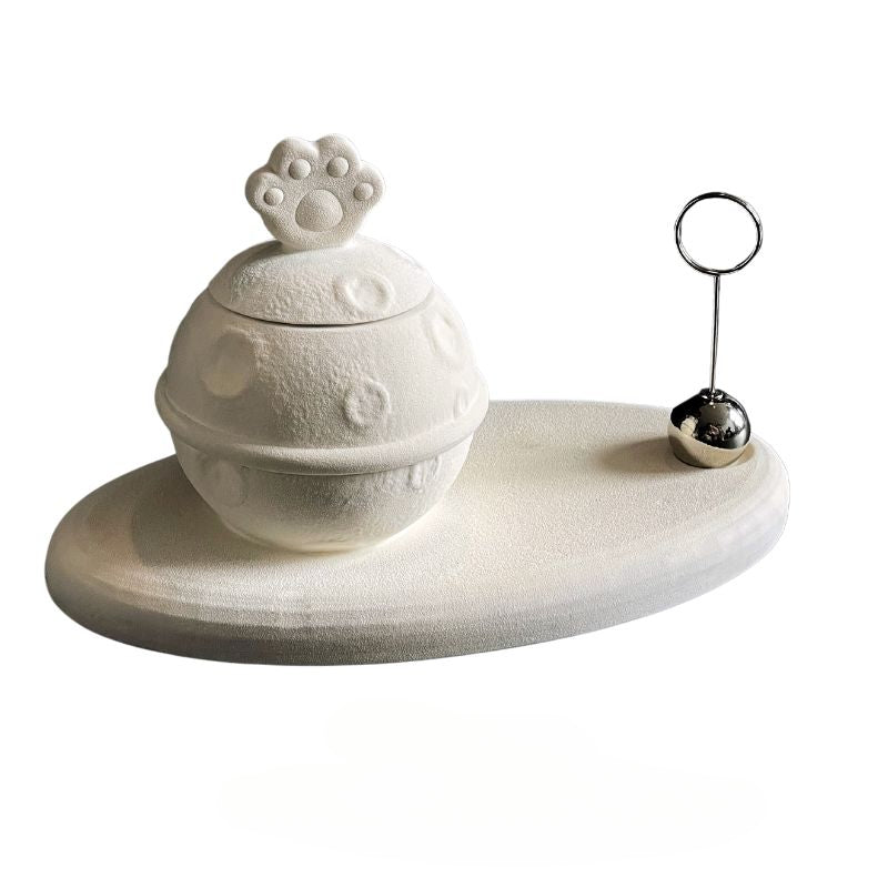 This white moon paw ceramic pet urn features a unique moon-shaped design with a paw print lid and detachable photo frame, measuring 22cm wide and 8cm tall with a 1-2cm base, holding 250ml of ashes. Perfect for North American pet owners honoring small pets like cats or dogs, it offers secure storage and a personalized memorial display for shelves or tables.