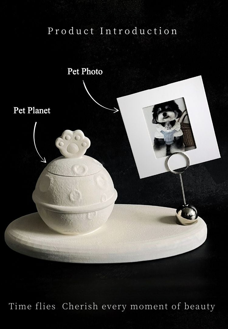 This white moon paw ceramic pet urn features a unique moon-shaped design with a paw print lid and detachable photo frame, measuring 22cm wide and 8cm tall with a 1-2cm base, holding 250ml of ashes. Perfect for North American pet owners honoring small pets like cats or dogs, it offers secure storage and a personalized memorial display for shelves or tables.