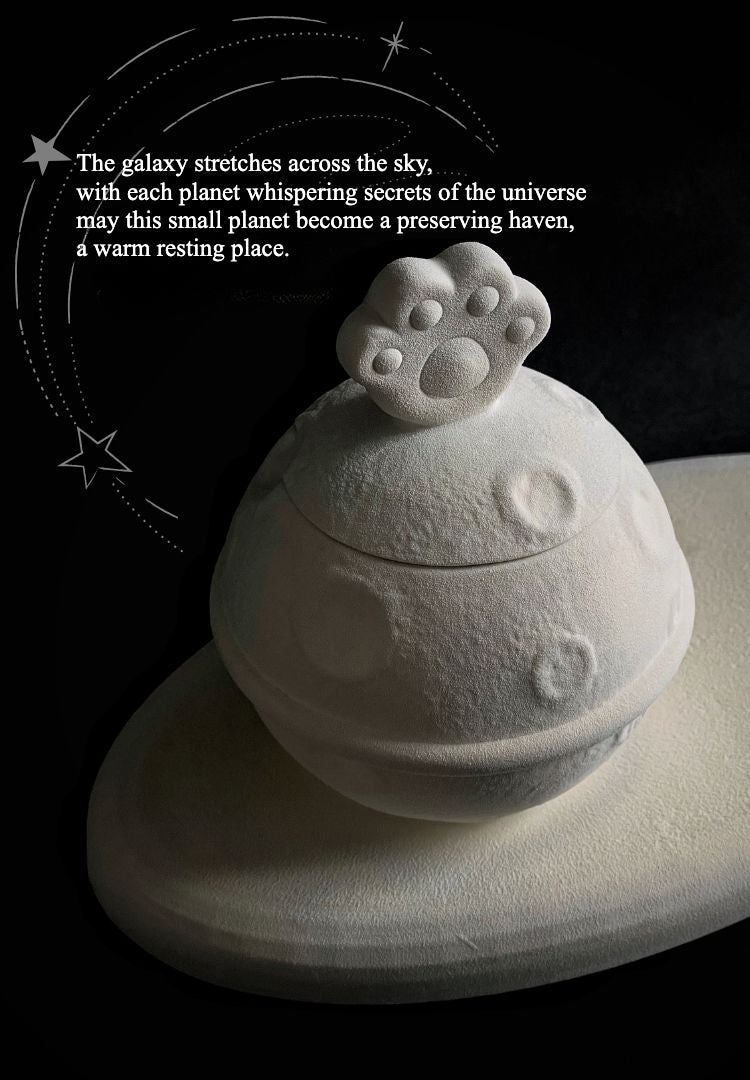 This white moon paw ceramic pet urn features a unique moon-shaped design with a paw print lid and detachable photo frame, measuring 22cm wide and 8cm tall with a 1-2cm base, holding 250ml of ashes. Perfect for North American pet owners honoring small pets like cats or dogs, it offers secure storage and a personalized memorial display for shelves or tables.
