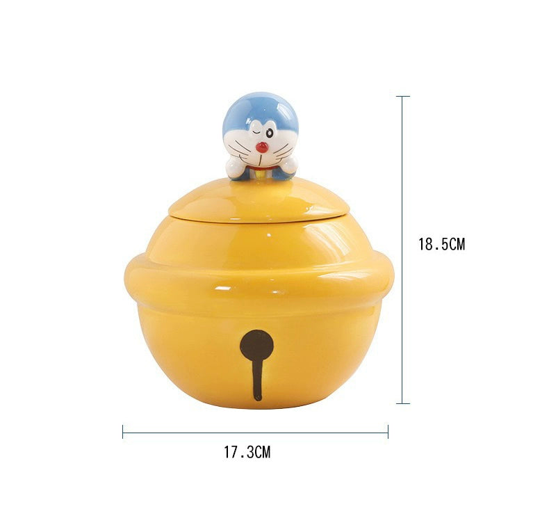 Yellow ceramic Doraemon pet cremation urn with a glossy finish, featuring a round shape and a cute Doraemon figure on top, ideal for North American pet owners. This handcrafted urn provides secure ashes storage, perfect for home memorial display on mantels or shelves, with a vibrant yellow hue and playful design.