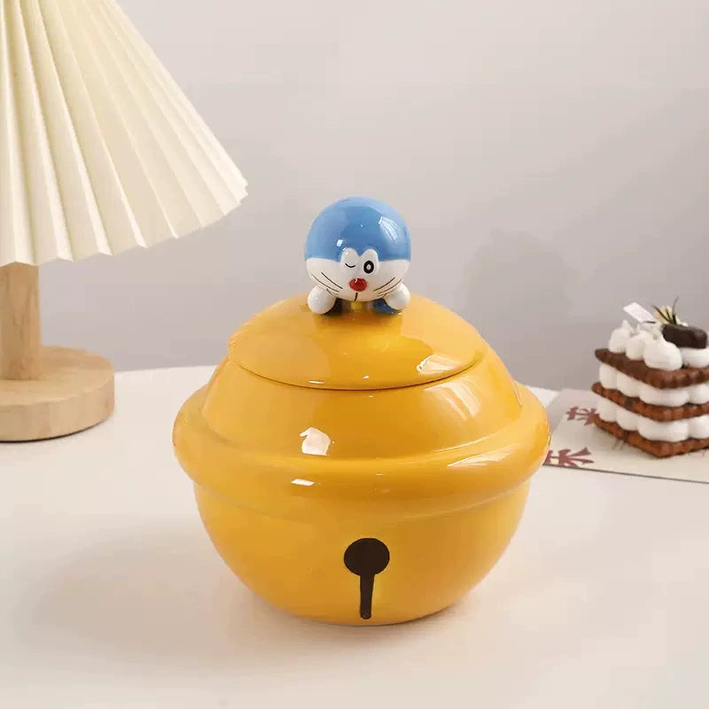 Yellow ceramic Doraemon pet cremation urn with a glossy finish, featuring a round shape and a cute Doraemon figure on top, ideal for North American pet owners. This handcrafted urn provides secure ashes storage, perfect for home memorial display on mantels or shelves, with a vibrant yellow hue and playful design.