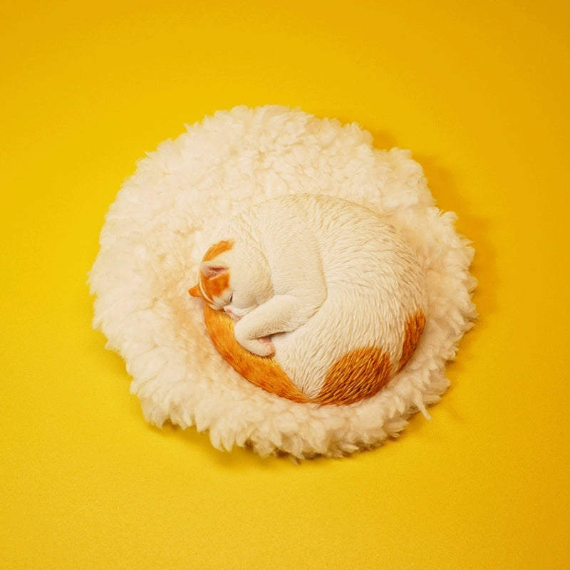 An intricately detailed 1/6 scale resin model of an orange cat sleeping curled up on a fluffy white cushion. The realistic texture and serene posture make it a perfect collectible for cat lovers.