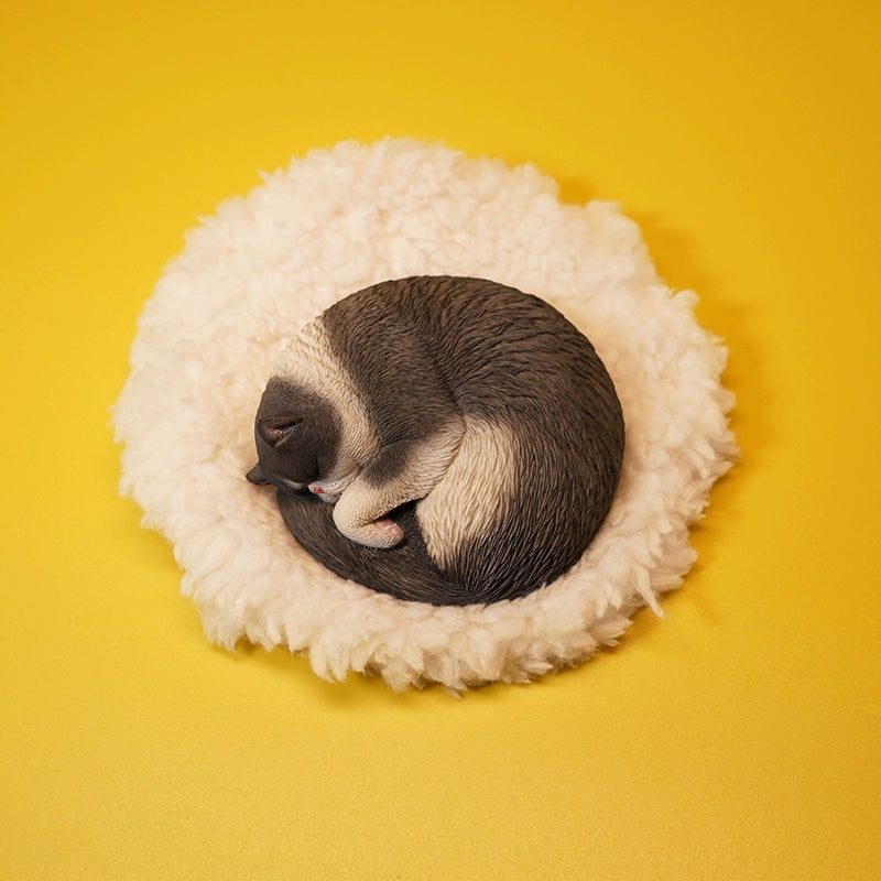 An intricately detailed 1/6 scale resin model of an orange cat sleeping curled up on a fluffy white cushion. The realistic texture and serene posture make it a perfect collectible for cat lovers.