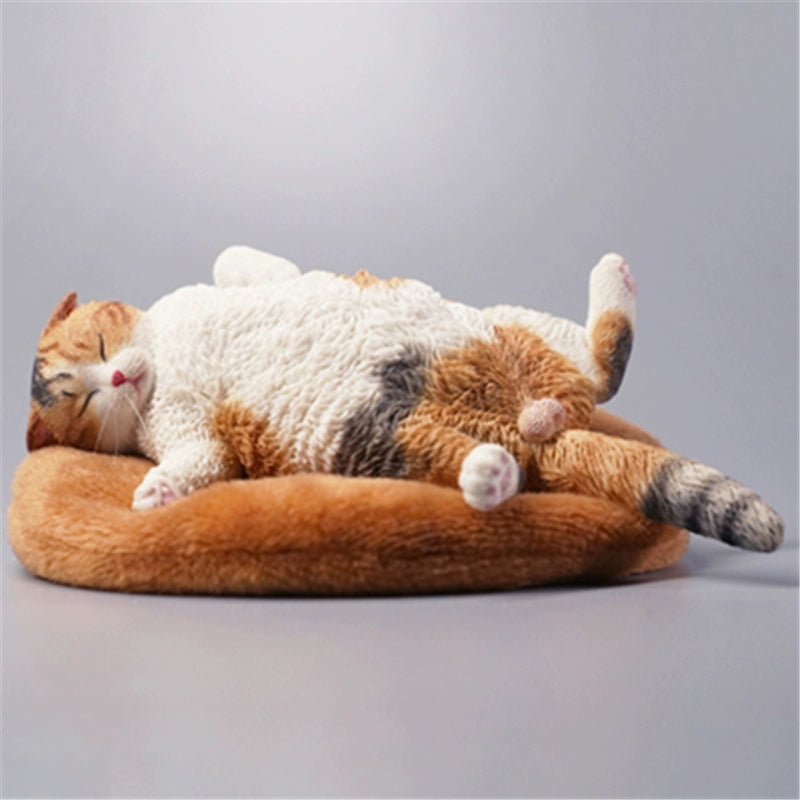 A highly detailed 1/6 scale resin model of an orange cat peacefully curled up on a fluffy white cushion. This simulation captures the cat's lifelike texture and serene demeanor, making it an exquisite collectible.